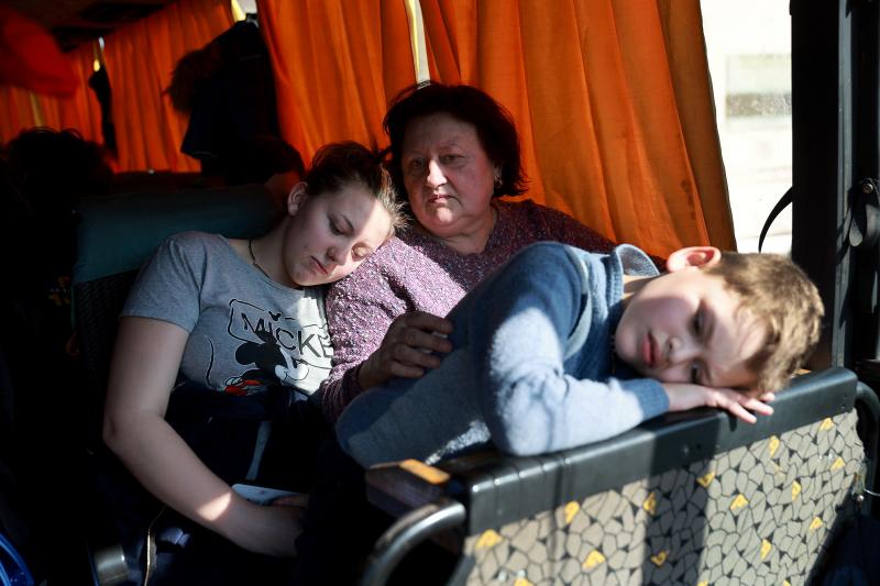 Sywasz Elizabeth, Samarska Ludmyla and Pylypenko Arsenij wait on a bus after arriving safely on a train in Lviv, Ukraine, from the Ukrainian city of Mariupol, which has been under heavy Russian military attack, on Tuesday. Trains carried hundreds of evacu Sywasz Elizabeth, Samarska Ludmyla and Pylypenko Arsenij wait on a bus after arriving safely on a train in Lviv, Ukraine, from the Ukrainian city of Mariupol, which has been under heavy Russian military attack, on Tuesday. Trains carried hundreds of evacu
