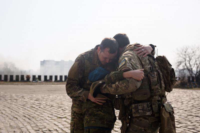 Ukrainian servicemen comfort Daniil, 12, the son of Vladyslav Buvalkin, 42, who died in action and was buried on Wednesday in Kyiv, Ukraine. Ukrainian forces have managed to fend off Russian advances near the capital, although shellfire and aerial bombard Ukrainian servicemen comfort Daniil, 12, the son of Vladyslav Buvalkin, 42, who died in action and was buried on Wednesday in Kyiv, Ukraine. Ukrainian forces have managed to fend off Russian advances near the capital, although shellfire and aerial bombard