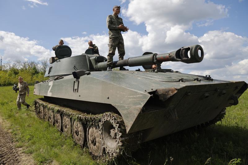 Russian-backed Donetsk militia fighters man "Gvozdika" (Carnation) self-propelled artillery vehicles to fire toward a Ukrainian army position outside Donetsk, in territory held by the separatist Donetsk government in eastern Ukraine, Friday. Fighting has Russian-backed Donetsk militia fighters man "Gvozdika" (Carnation) self-propelled artillery vehicles to fire toward a Ukrainian army position outside Donetsk, in territory held by the separatist Donetsk government in eastern Ukraine, Friday. Fighting has