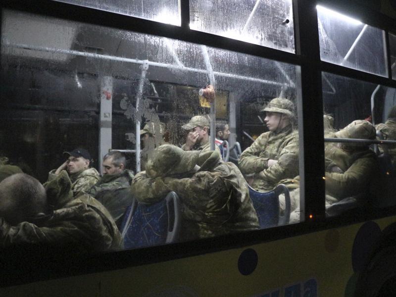 Ukrainian servicemen from the Azovstal steel plant sit on a bus near a penal colony, in Olyonivka, in territory under the government of the Donetsk People's Republic, on Friday. Ukrainian servicemen from the Azovstal steel plant sit on a bus near a penal colony, in Olyonivka, in territory under the government of the Donetsk People's Republic, on Friday.