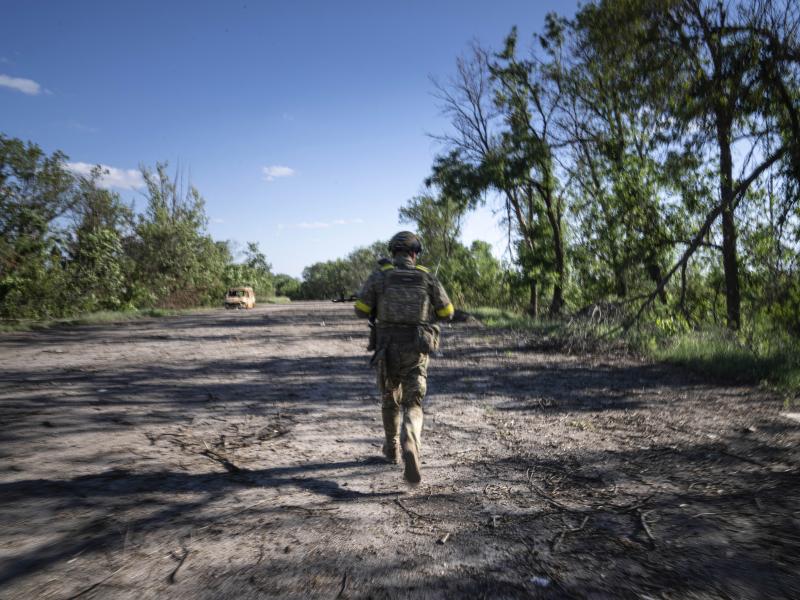 A Ukrainian serviceman changes his position at the frontline near Kharkiv, Ukraine, on Saturday, July 2, 2022. A Ukrainian serviceman changes his position at the frontline near Kharkiv, Ukraine, on Saturday, July 2, 2022.