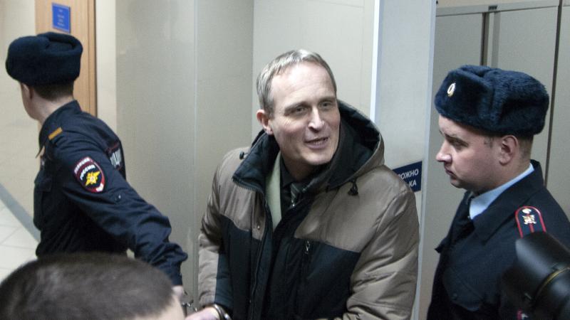 Dennis Christensen, a Danish Jehovah's Witness, is escorted from a court room in Orel, Russia, on Wednesday. Dennis Christensen, a Danish Jehovah's Witness, is escorted from a court room in Orel, Russia, on Wednesday.