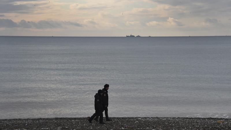 Russian police patrol the shores along the Black Sea at Sochi on Monday, one day after a Russian military plane crashed into the sea. An extensive search effort has revealed no sign of survivors among the 92 on board. Russian police patrol the shores along the Black Sea at Sochi on Monday, one day after a Russian military plane crashed into the sea. An extensive search effort has revealed no sign of survivors among the 92 on board.