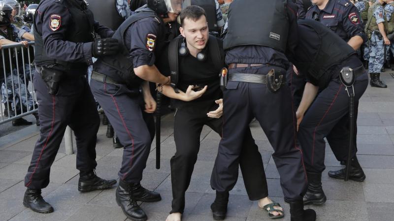 Police officers detain a man at protests in Moscow. Hundreds have been arrested during a demonstration demanding that opposition candidates be allowed to run for the Moscow city council. Police officers detain a man at protests in Moscow. Hundreds have been arrested during a demonstration demanding that opposition candidates be allowed to run for the Moscow city council.