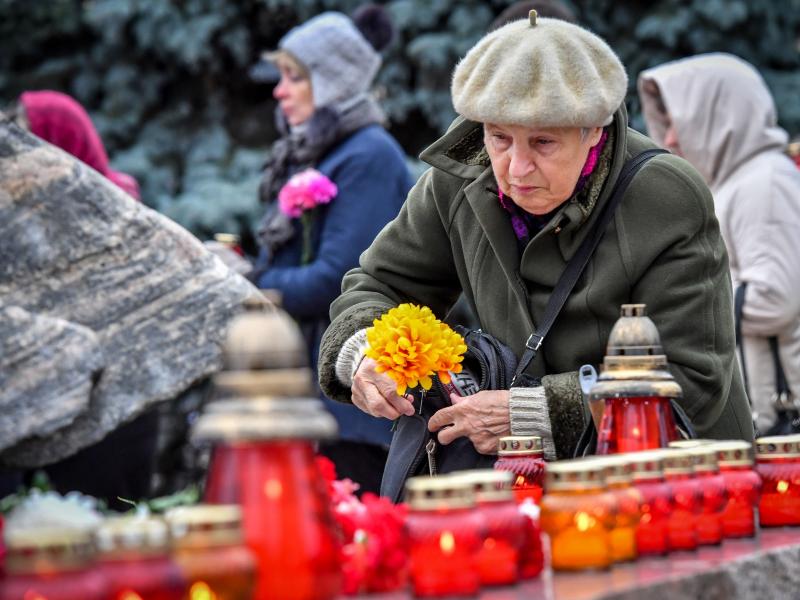A woman places flowers at the Solovetsky Stone monument in front of the former KGB headquarters in central Moscow on Monday. Dozens of people gathered there to remember the victims of Soviet-era political repressions. A woman places flowers at the Solovetsky Stone monument in front of the former KGB headquarters in central Moscow on Monday. Dozens of people gathered there to remember the victims of Soviet-era political repressions.