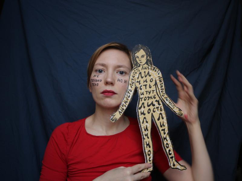 A self-portrait of Darya Apakhonchich, with the writing on her face and a figure of a woman saying: "Not only a body but a person, person, person, person, person." She made the photo in support of Russian artist and LGBTQ activist Yulia Tsvetkova, who fac A self-portrait of Darya Apakhonchich, with the writing on her face and a figure of a woman saying: "Not only a body but a person, person, person, person, person." She made the photo in support of Russian artist and LGBTQ activist Yulia Tsvetkova, who fac