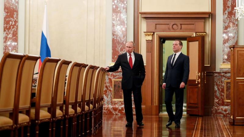 Russian President Vladimir Putin and Prime Minister Dmitry Medvedev speak before a meeting with members of the government Wednesday in Moscow. The Cabinet members resigned after Putin proposed a series of constitutional changes, according to Russian news Russian President Vladimir Putin and Prime Minister Dmitry Medvedev speak before a meeting with members of the government Wednesday in Moscow. The Cabinet members resigned after Putin proposed a series of constitutional changes, according to Russian news
