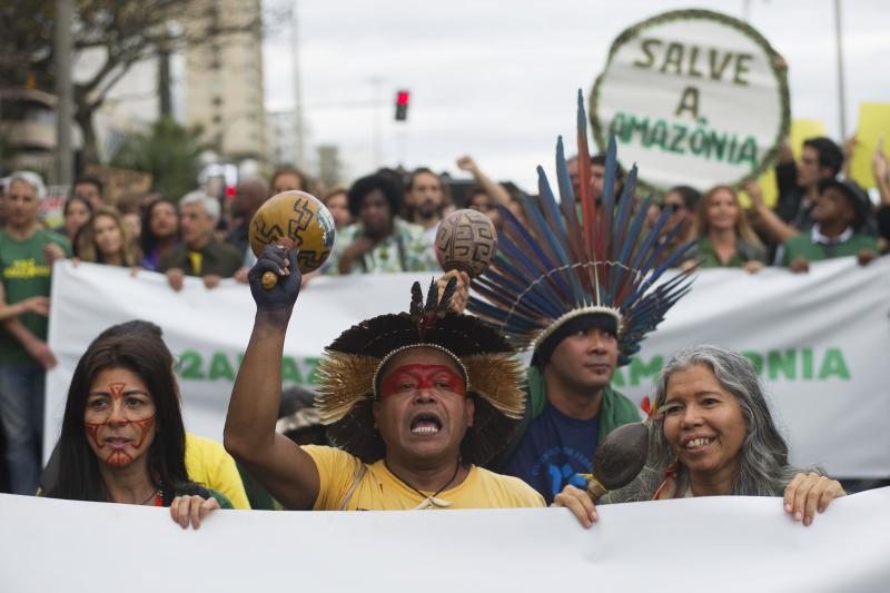 Indigenous people protest in defense of the Amazon in Rio de Janeiro on Sunday. Experts from the country's satellite monitoring agency say most of the fires are set by farmers or ranchers clearing existing farmland, but the same monitoring agency has repo Indigenous people protest in defense of the Amazon in Rio de Janeiro on Sunday. Experts from the country's satellite monitoring agency say most of the fires are set by farmers or ranchers clearing existing farmland, but the same monitoring agency has repo