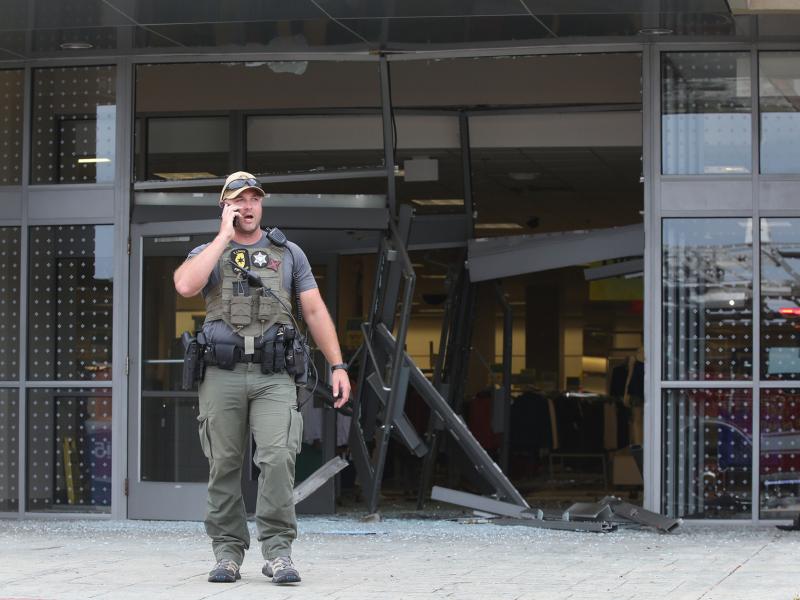 A state police officer stands outside a Woodfield Mall entrance on Friday, in Schaumburg, Ill. An SUV drove into the mall through the Sears entrance and crashed into several stores and kiosks. A state police officer stands outside a Woodfield Mall entrance on Friday, in Schaumburg, Ill. An SUV drove into the mall through the Sears entrance and crashed into several stores and kiosks.