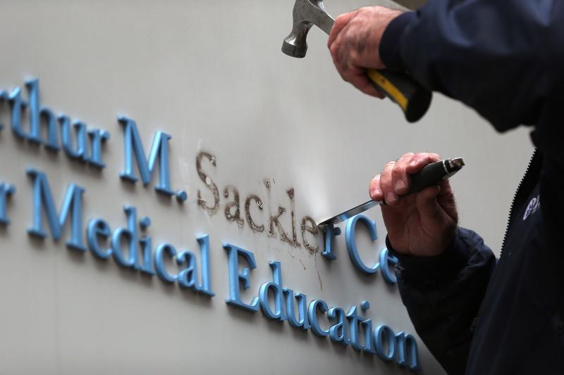 Tufts employee Gabe Ryan removes the Sackler family name from a building at Tufts University, the first major university to strip the Sackler name from buildings and programs. Tufts employee Gabe Ryan removes the Sackler family name from a building at Tufts University, the first major university to strip the Sackler name from buildings and programs.