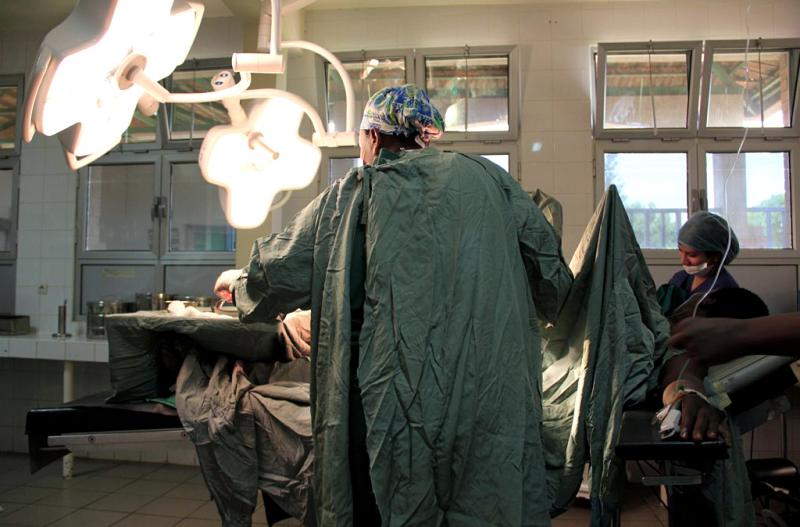 A surgeon and nurse anesthetist a baby by emergency cesarean section at a hospital in Rwanda. A surgeon and nurse anesthetist a baby by emergency cesarean section at a hospital in Rwanda.