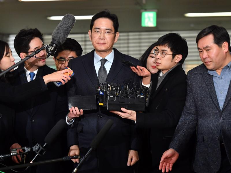 Lee Jae-yong (center), vice chairman of Samsung Electronics, arrives Monday for questioning as a suspect in the corruption scandal that led to the impeachment of South Korea's President Park Geun-Hye. Lee Jae-yong (center), vice chairman of Samsung Electronics, arrives Monday for questioning as a suspect in the corruption scandal that led to the impeachment of South Korea's President Park Geun-Hye.