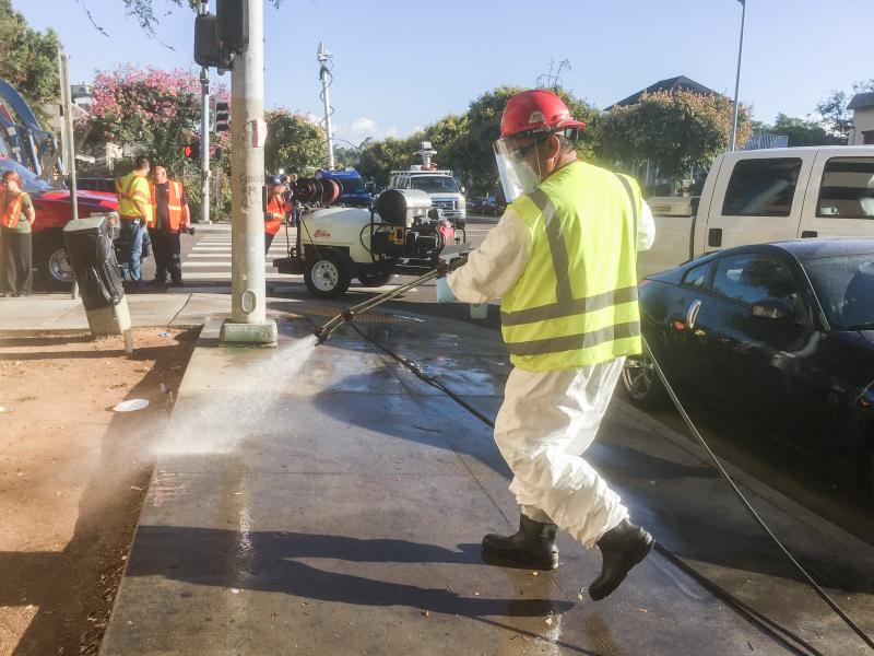 City workers wash down streets and sidewalks Monday in an effort to control a hepatitis A outbreak in San Diego. City workers wash down streets and sidewalks Monday in an effort to control a hepatitis A outbreak in San Diego.