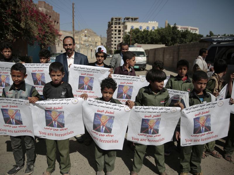 Boys hold posters with crossed-out pictures of President Trump during an April march against plans by the Arab coalition to attack Hodeidah, Yemen. Boys hold posters with crossed-out pictures of President Trump during an April march against plans by the Arab coalition to attack Hodeidah, Yemen.
