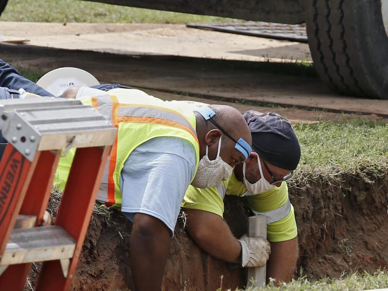 Workers reinforce the sides of an excavation site during the search for a potential unmarked mass grave from the 1921 Tulsa Race Massacre, at Oaklawn Cemetery in Tulsa, Okla., in July. Workers reinforce the sides of an excavation site during the search for a potential unmarked mass grave from the 1921 Tulsa Race Massacre, at Oaklawn Cemetery in Tulsa, Okla., in July.