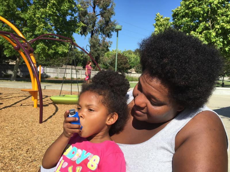 Zunika Crenshaw helps her 3-year-old daughter Jhase Crenshaw Bass with an asthma inhaler. Zunika Crenshaw helps her 3-year-old daughter Jhase Crenshaw Bass with an asthma inhaler.