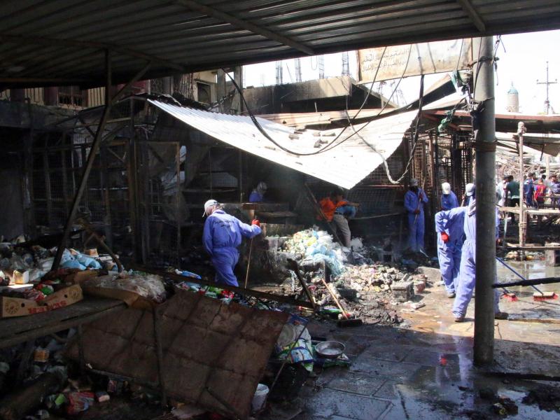 Iraqi workers clean the site of a truck bomb attack that hit the area a day earlier at Khan bani Saad town, eastern Baghdad, Iraq, on Saturday. At least 115 people were killed in what's described as the single deadliest such attack in the country in a dec Iraqi workers clean the site of a truck bomb attack that hit the area a day earlier at Khan bani Saad town, eastern Baghdad, Iraq, on Saturday. At least 115 people were killed in what's described as the single deadliest such attack in the country in a dec