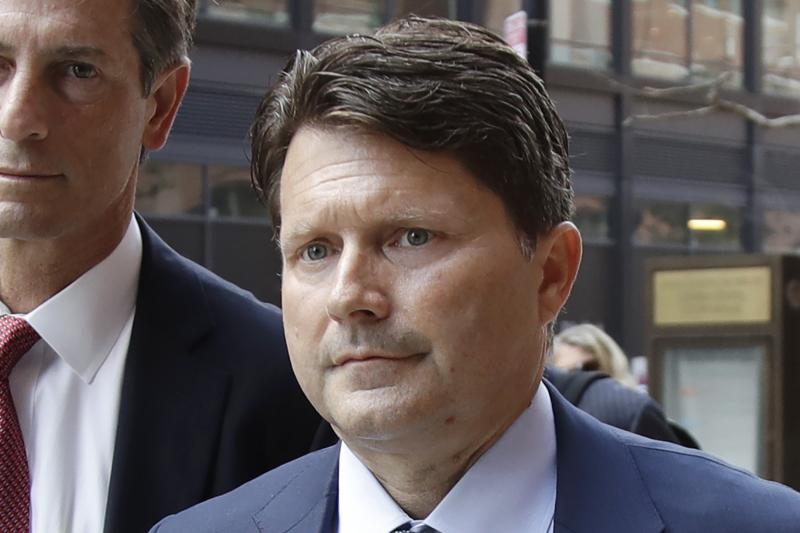 Devin Sloane (right) arrives at federal court in Boston on Tuesday for sentencing in a nationwide college admissions bribery scandal. Sloane admitted to paying $250,000 to get his son into the University of Southern California as a fake water polo player. Devin Sloane (right) arrives at federal court in Boston on Tuesday for sentencing in a nationwide college admissions bribery scandal. Sloane admitted to paying $250,000 to get his son into the University of Southern California as a fake water polo player.