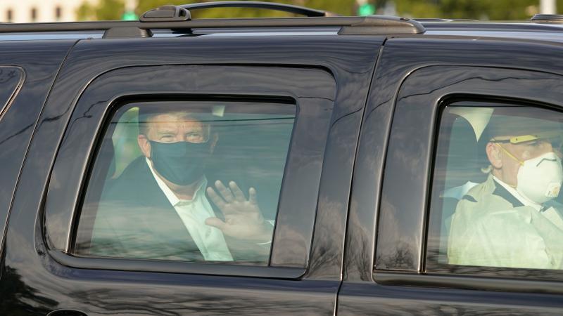 President Trump waves from a motorcade outside Walter Reed Medical Center, accompanied by Secret Service agents on Sunday. President Trump waves from a motorcade outside Walter Reed Medical Center, accompanied by Secret Service agents on Sunday.