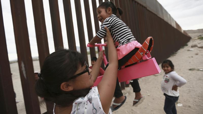 A set of pink seesaws allowed people to share some fun along the U.S.-Mexico border wall this week. Here, a woman helps her little girls ride the seesaw that was installed near Ciudad de Juarez, Mexico. A set of pink seesaws allowed people to share some fun along the U.S.-Mexico border wall this week. Here, a woman helps her little girls ride the seesaw that was installed near Ciudad de Juarez, Mexico.
