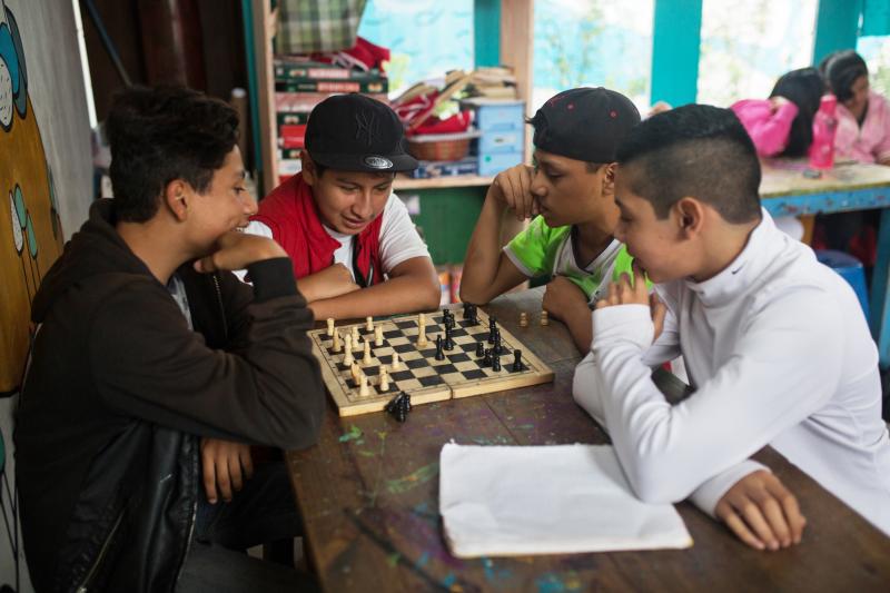 Teenagers play chess during a break at the main Los Patojos campus. Teenagers play chess during a break at the main Los Patojos campus.
