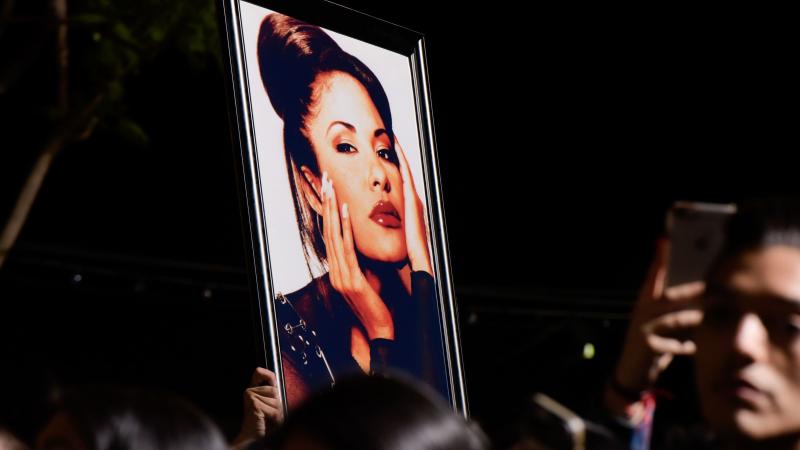 Fans with a photo of Selena during a ceremony honoring her in 2017. Over the decades since her death, Selena's legacy has become even more profound than writer Deborah Paredez ever anticipated. Fans with a photo of Selena during a ceremony honoring her in 2017. Over the decades since her death, Selena's legacy has become even more profound than writer Deborah Paredez ever anticipated.
