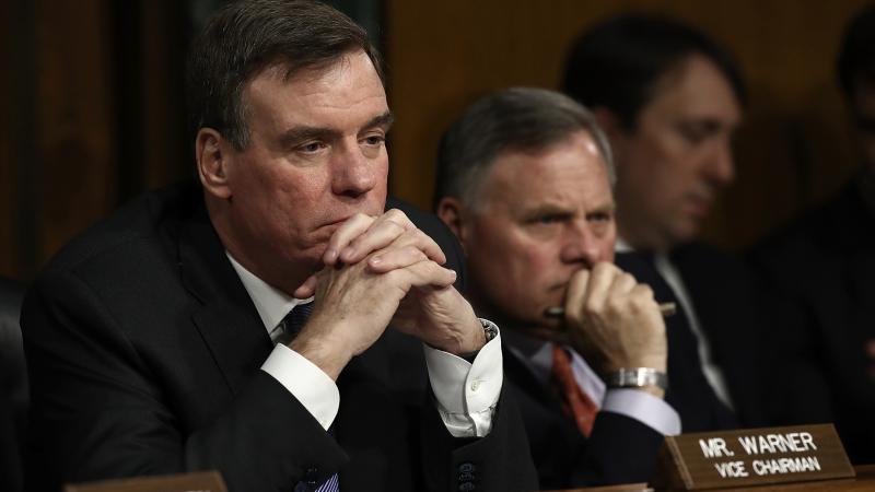 Mark Warner (from left) of Virginia, the top Democrat on the Senate Intelligence Committee, and Republican Chairman Richard Burr of North Carolina listen to testimony during a March 30 hearing in Washington, D.C. Mark Warner (from left) of Virginia, the top Democrat on the Senate Intelligence Committee, and Republican Chairman Richard Burr of North Carolina listen to testimony during a March 30 hearing in Washington, D.C.