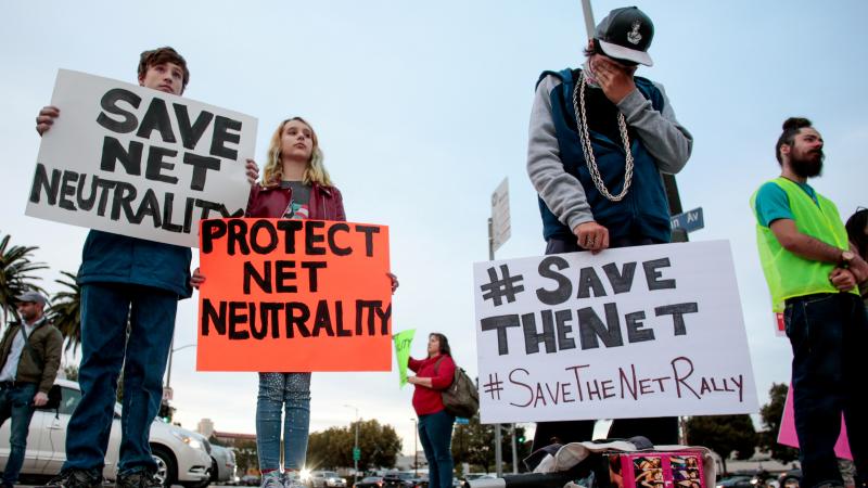 Senate Democrats say they have the votes to formally disapprove of the FCC's Internet policy that will take effect next month. Here, supporters of net neutrality protest the decision to repeal the Obama-era rule. Senate Democrats say they have the votes to formally disapprove of the FCC's Internet policy that will take effect next month. Here, supporters of net neutrality protest the decision to repeal the Obama-era rule.