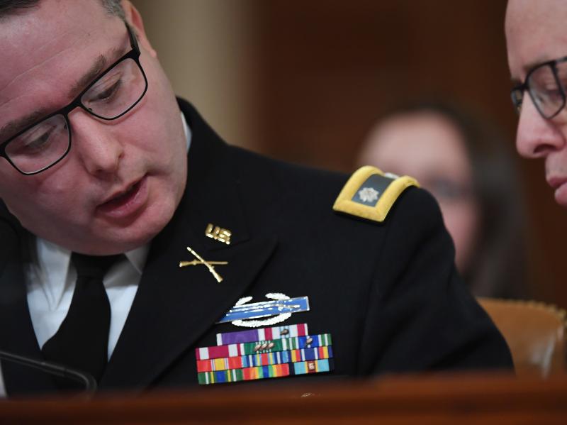 National Security Council Europe expert Lt. Col. Alexander Vindman (left) appears before the House Intelligence Committee during an impeachment hearing in November. National Security Council Europe expert Lt. Col. Alexander Vindman (left) appears before the House Intelligence Committee during an impeachment hearing in November.
