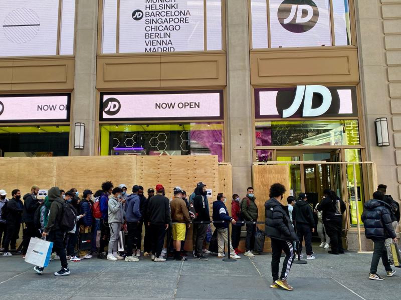 People wait in line outside for their turn to enter the JD Sports store in New York City on Nov. 5. People wait in line outside for their turn to enter the JD Sports store in New York City on Nov. 5.