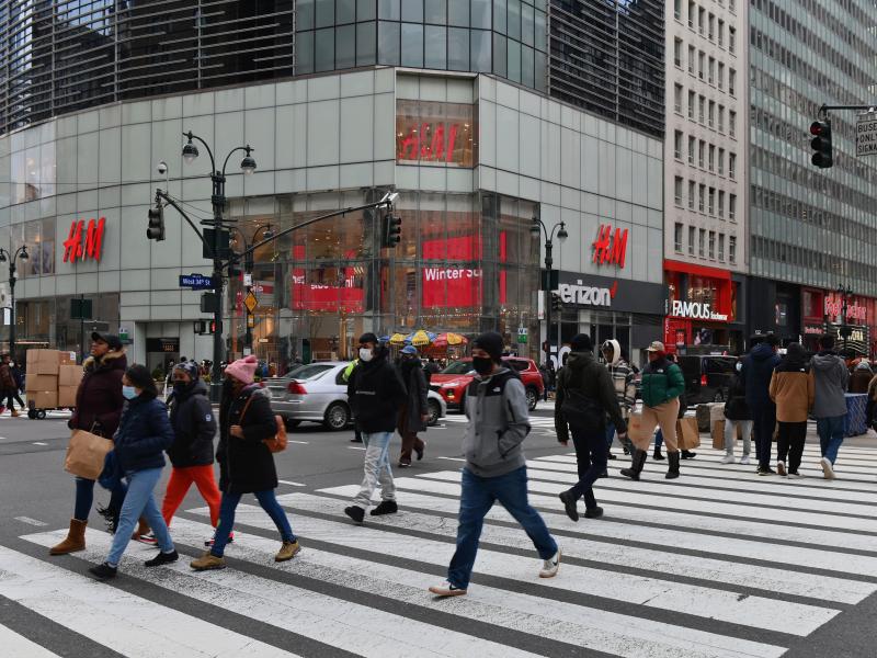 People walk in front of stores in New York's Herald Square. Retail sales soared 5.3% last month compared to December as U.S. families began receiving new federal coronavirus relief checks. People walk in front of stores in New York's Herald Square. Retail sales soared 5.3% last month compared to December as U.S. families began receiving new federal coronavirus relief checks.