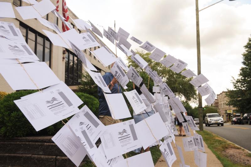 A rally outside the Montclair, N.J., town hall on July 1. Protesters hung 1,101 absentee ballots to represent the number of votes that weren't counted in a mayoral election that was decided by just 195 votes. A rally outside the Montclair, N.J., town hall on July 1. Protesters hung 1,101 absentee ballots to represent the number of votes that weren't counted in a mayoral election that was decided by just 195 votes.