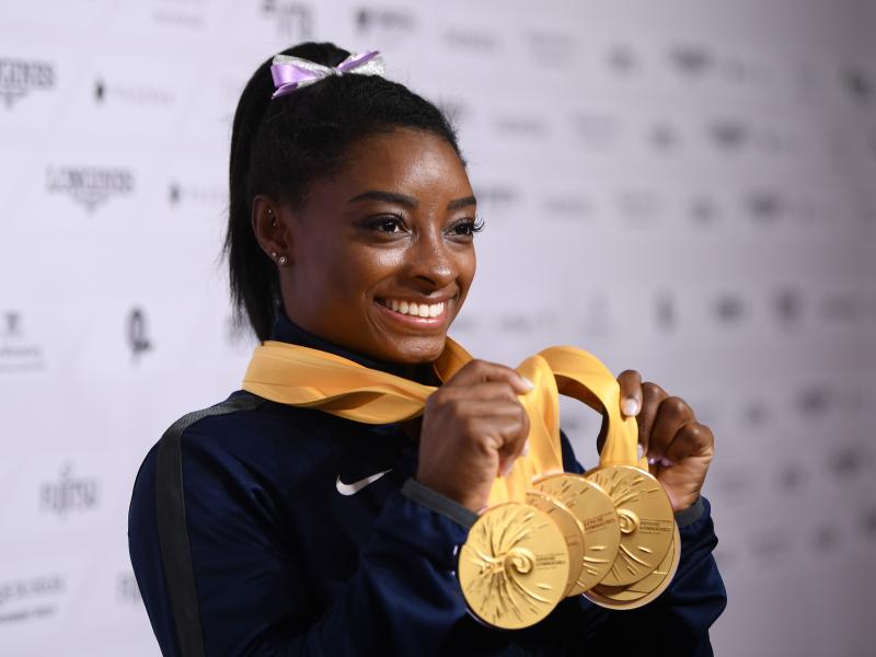 U.S. gymnast Simone Biles poses with her five gold meals at the 2019 World Championships in Stuttgart, Germany. With her wins, she becomes the most decorated gymnast ever at the world championships, with 25 total medals. U.S. gymnast Simone Biles poses with her five gold meals at the 2019 World Championships in Stuttgart, Germany. With her wins, she becomes the most decorated gymnast ever at the world championships, with 25 total medals.