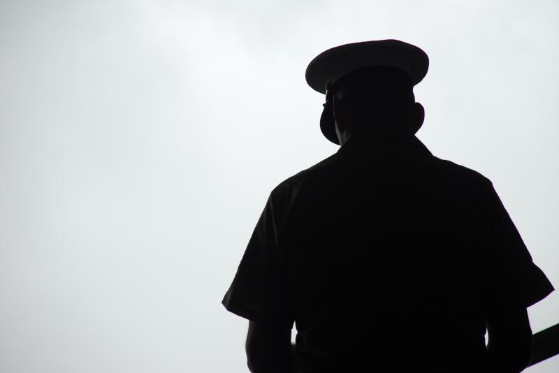 Silhouette of a United States Marine praying, photographed from behind. Silhouette of a United States Marine praying, photographed from behind.