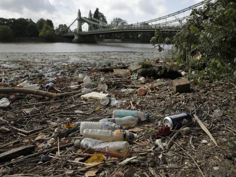 Single-use plastic bottles lie washed up on the bank of the River Thames by the Queen Caroline Draw Dock in London. Single-use plastic bottles lie washed up on the bank of the River Thames by the Queen Caroline Draw Dock in London.