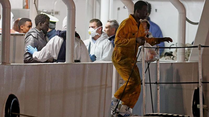 Italian authorities aboard the Italian coast guard vessel Bruno Gregoretti check on migrants who survived a recent sinking in the Mediterranean Sea. The coast guard vessel arrived at Catania's port in Sicily on Tuesday. Italian authorities aboard the Italian coast guard vessel Bruno Gregoretti check on migrants who survived a recent sinking in the Mediterranean Sea. The coast guard vessel arrived at Catania's port in Sicily on Tuesday.