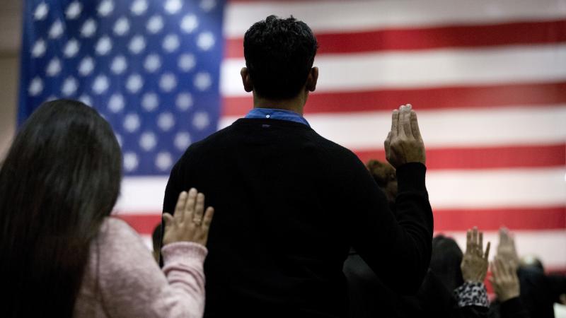 People take the oath of allegiance to become U.S. citizens during a naturalization ceremony at the Los Angeles Convention Center in 2017. People take the oath of allegiance to become U.S. citizens during a naturalization ceremony at the Los Angeles Convention Center in 2017.