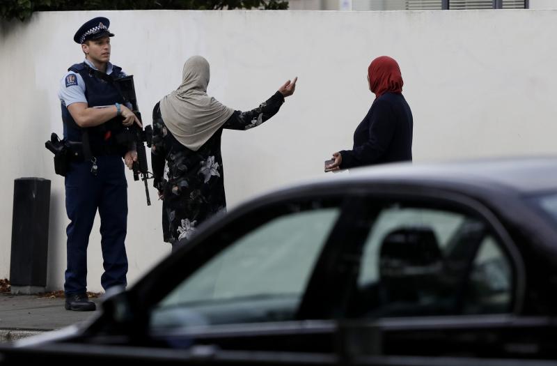 A police officer directs pedestrians near the site of one of the mass shootings at two mosques in Christchurch, New Zealand, on Saturday, March 16. A police officer directs pedestrians near the site of one of the mass shootings at two mosques in Christchurch, New Zealand, on Saturday, March 16.