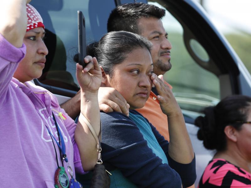 Friends, co-workers and family watch as U.S. immigration officials raid the Koch Foods Inc. plant in Morton, Miss., on Wednesday. Friends, co-workers and family watch as U.S. immigration officials raid the Koch Foods Inc. plant in Morton, Miss., on Wednesday.