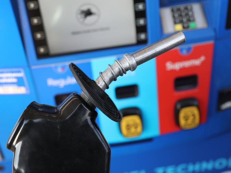 A gas pump nozzle is seen at a Miami gas station in 2018. Some activist shareholders are pushing companies to tie executive compensation to meeting climate targets. A gas pump nozzle is seen at a Miami gas station in 2018. Some activist shareholders are pushing companies to tie executive compensation to meeting climate targets.