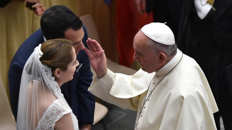 Pope Francis blesses a newlywed couple during his weekly audience in the Paul VI hall in Vatican City on Aug. 12, 2015. Pope Francis blesses a newlywed couple during his weekly audience in the Paul VI hall in Vatican City on Aug. 12, 2015.