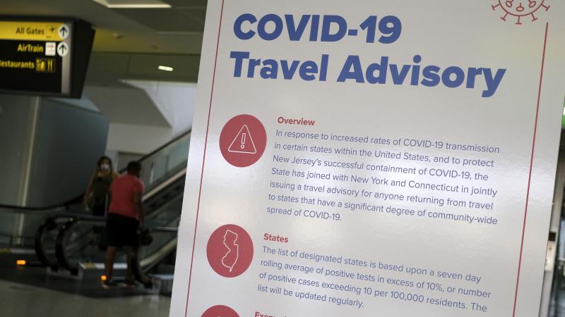 A sign at Newark Liberty International Airport warns airline passengers about a travel advisory that applies to people arriving in New Jersey from certain states. Visitors from Alabama, Arkansas, Arizona, California, Florida, Georgia, Iowa, Idaho, Louisia A sign at Newark Liberty International Airport warns airline passengers about a travel advisory that applies to people arriving in New Jersey from certain states. Visitors from Alabama, Arkansas, Arizona, California, Florida, Georgia, Iowa, Idaho, Louisia