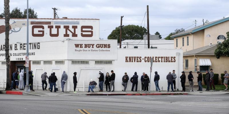 People wait in a line to enter a gun store in Culver City, Calif., on March 15, 2020. Coronavirus concerns have led to consumer panic buying of grocery staples, and now gun stores are seeing a similar run on weapons and ammunition as panic intensifies. People wait in a line to enter a gun store in Culver City, Calif., on March 15, 2020. Coronavirus concerns have led to consumer panic buying of grocery staples, and now gun stores are seeing a similar run on weapons and ammunition as panic intensifies.