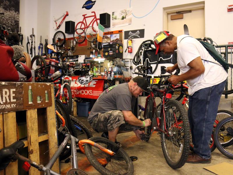 Jason Orth, manager of the Reading Bike Hub, fixes a bike for a customer. Jason Orth, manager of the Reading Bike Hub, fixes a bike for a customer.