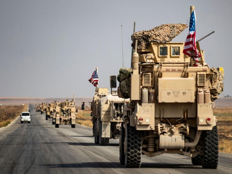 U.S. military vehicles drive on a road in the town of Tal Tamr on Sunday after pulling out of a base in northern Syria. Defense Secretary Mark Esper says some troops may remain in northeast Syria to secure oil fields. U.S. military vehicles drive on a road in the town of Tal Tamr on Sunday after pulling out of a base in northern Syria. Defense Secretary Mark Esper says some troops may remain in northeast Syria to secure oil fields.