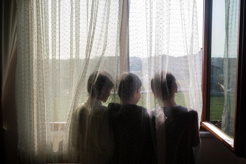 Ten-year-old Nurzat (right) and his friends, brothers Abdulla (left), 11, and Muhammet (center), 10, look out the window of their dormitory room at a boarding school in Istanbul, Turkey. The boys are all missing their parents, who are believed to be in pr Ten-year-old Nurzat (right) and his friends, brothers Abdulla (left), 11, and Muhammet (center), 10, look out the window of their dormitory room at a boarding school in Istanbul, Turkey. The boys are all missing their parents, who are believed to be in pr