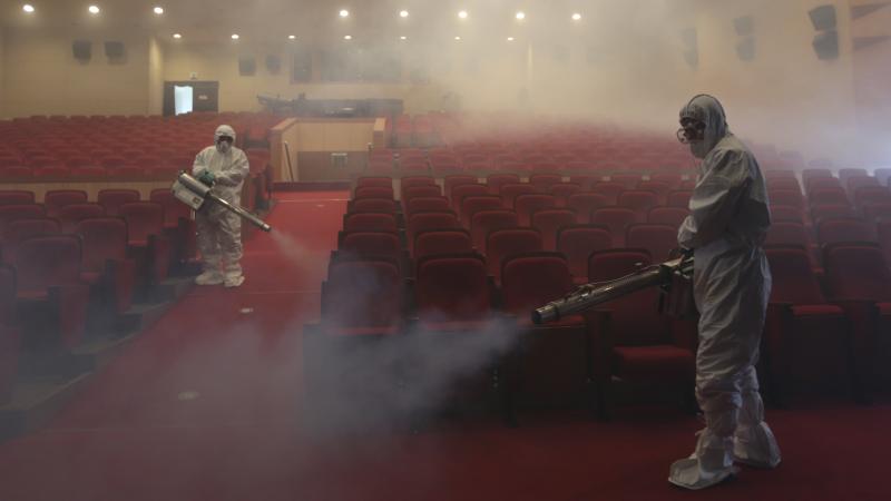 Workers wearing protective suits fumigate an art hall with antiseptic solution as a precaution against the spread of the Middle East respiratory syndrome in Seoul, South Korea, in June 2015. Workers wearing protective suits fumigate an art hall with antiseptic solution as a precaution against the spread of the Middle East respiratory syndrome in Seoul, South Korea, in June 2015.