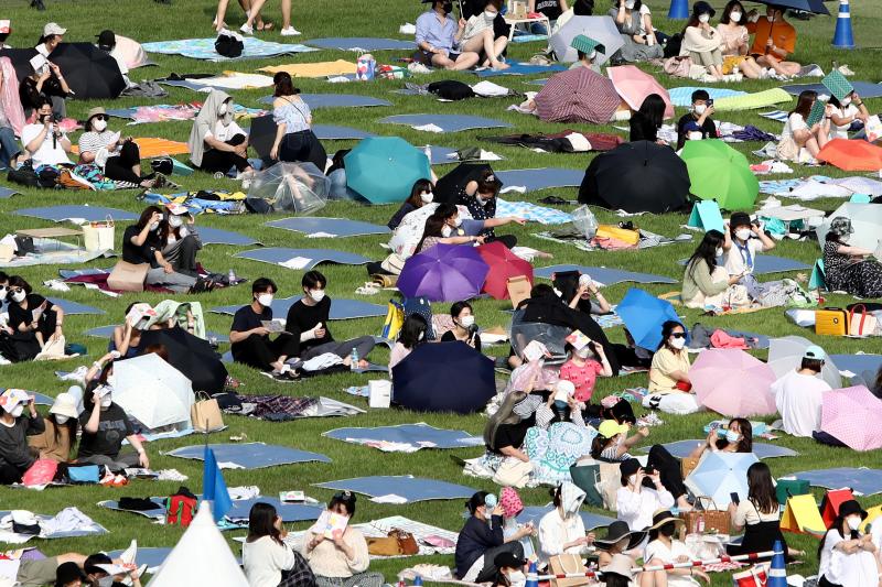 Festivalgoers attend a music festival at Olympic Park on June 26, 2021 in Seoul, South Korea. Festivalgoers attend a music festival at Olympic Park on June 26, 2021 in Seoul, South Korea.