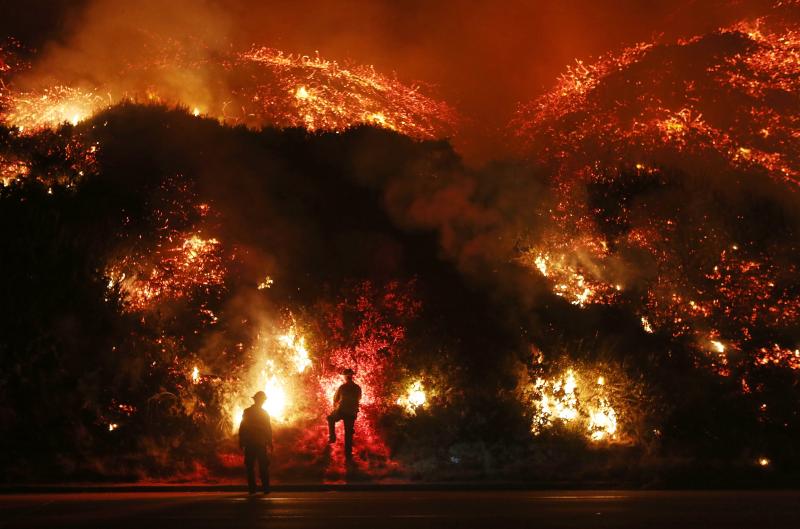 Firefighters monitor a section of the Thomas Fire along the 101 freeway north of Ventura. Firefighters monitor a section of the Thomas Fire along the 101 freeway north of Ventura.
