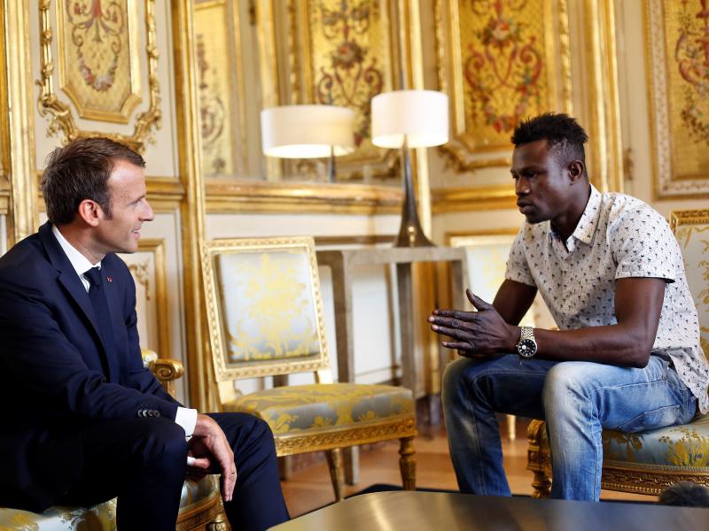 French President Emmanuel Macron speaks with Mamoudou Gassama at the presidential palace in Paris, on Monday. Macron offered Gassama citizenship for his "heroic act" in saving a four-year-old. French President Emmanuel Macron speaks with Mamoudou Gassama at the presidential palace in Paris, on Monday. Macron offered Gassama citizenship for his "heroic act" in saving a four-year-old.
